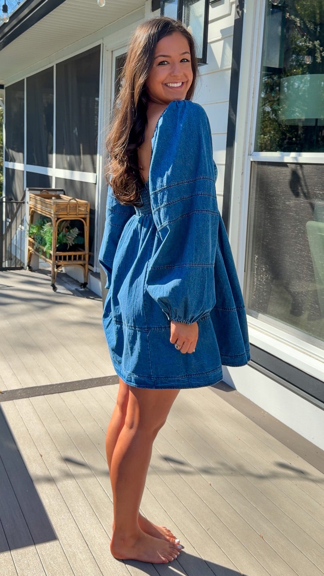 Women’s blue denim babydoll dress featuring a square neckline, long puff sleeves, and a loose, comfortable silhouette.