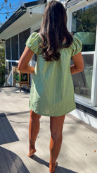 green striped babydoll mini dress with gathered neckline and pockets