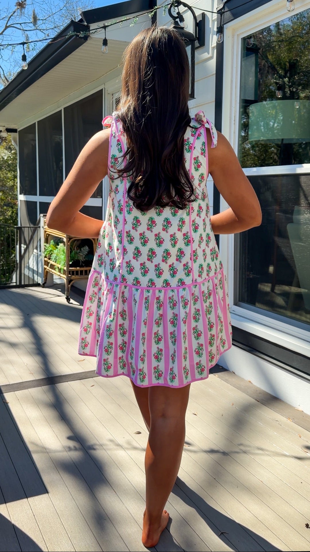 pink floral mini dress with ruffle hem and decorative shoulder bows