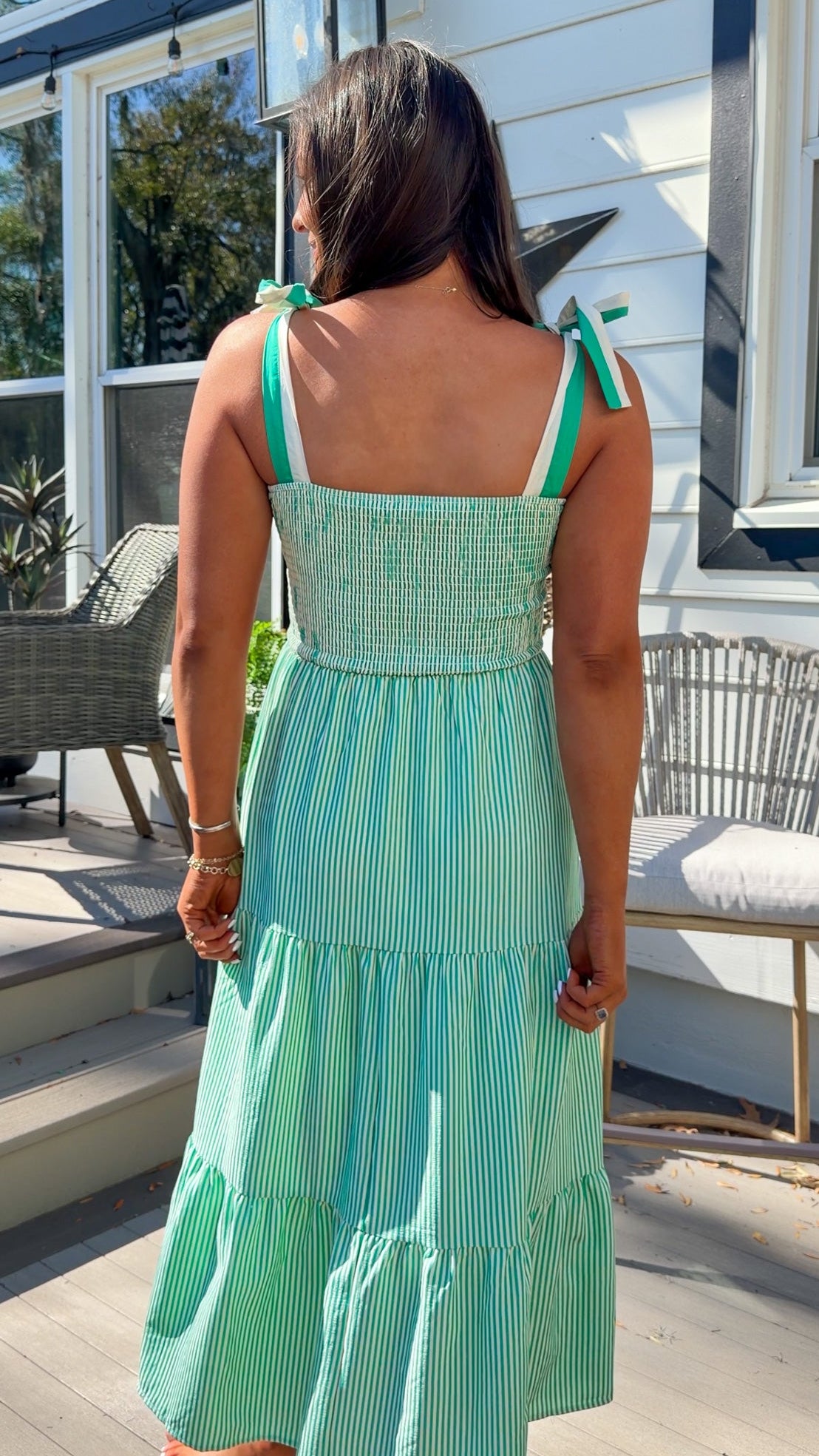 green striped tiered midi dress with bow tie straps and smocked back