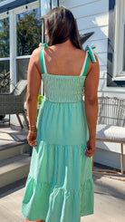 green striped tiered midi dress with bow tie straps and smocked back