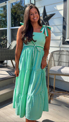 green striped tiered midi dress with bow tie straps and smocked back