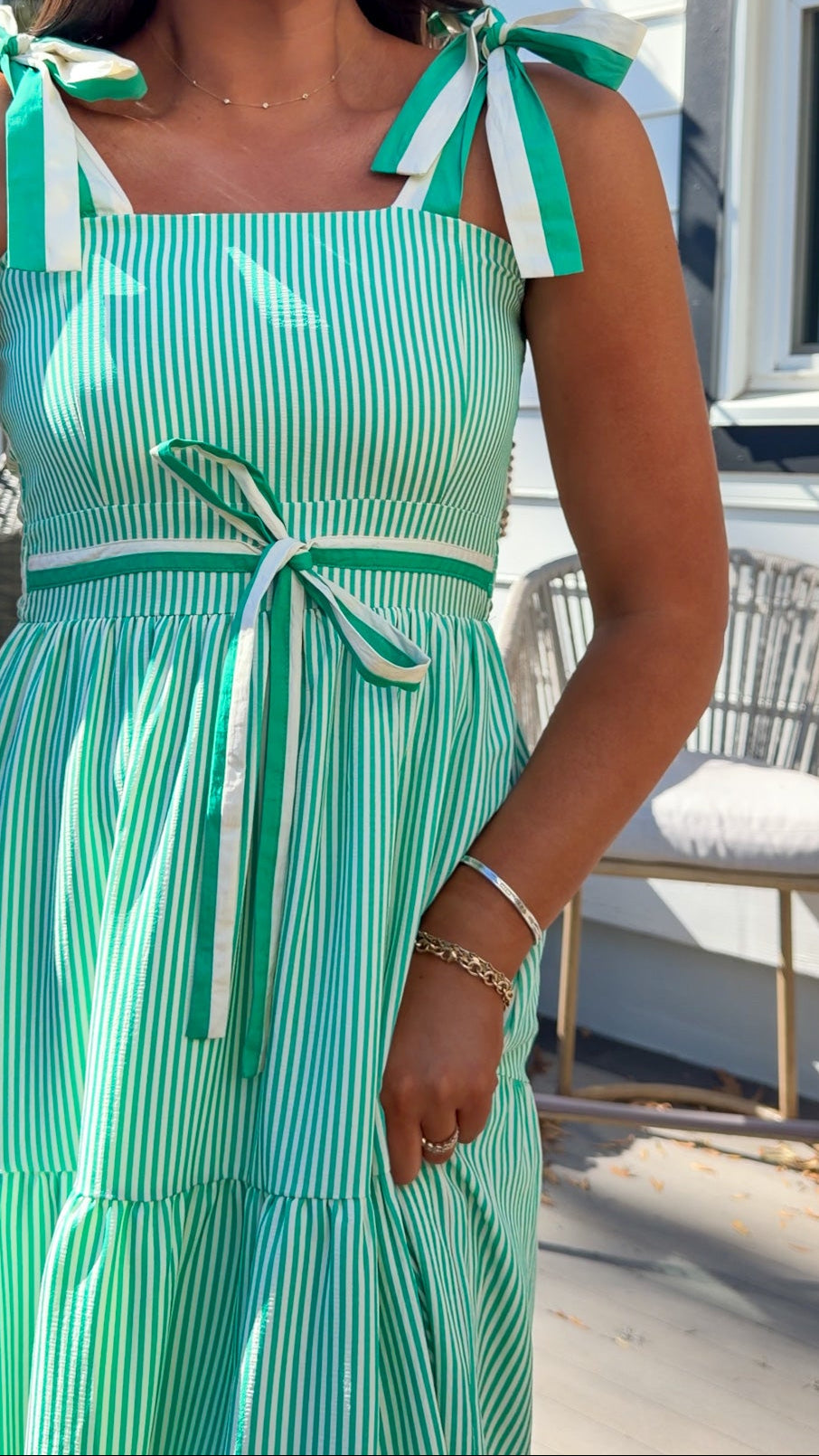 green striped tiered midi dress with bow tie straps and smocked back