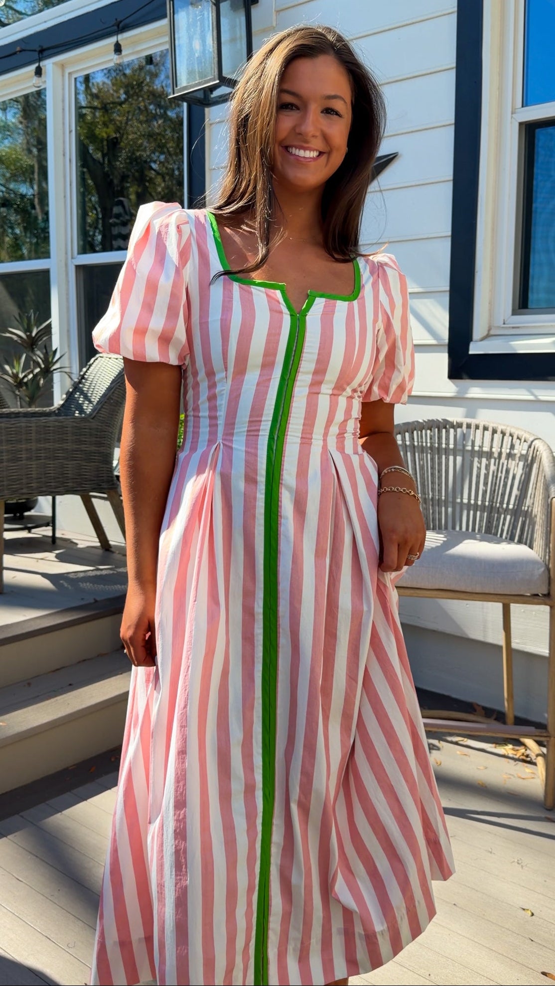 pink striped midi dress with green contrast trim and puff sleeves