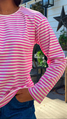 pink and white striped long sleeve knit top with relaxed fit