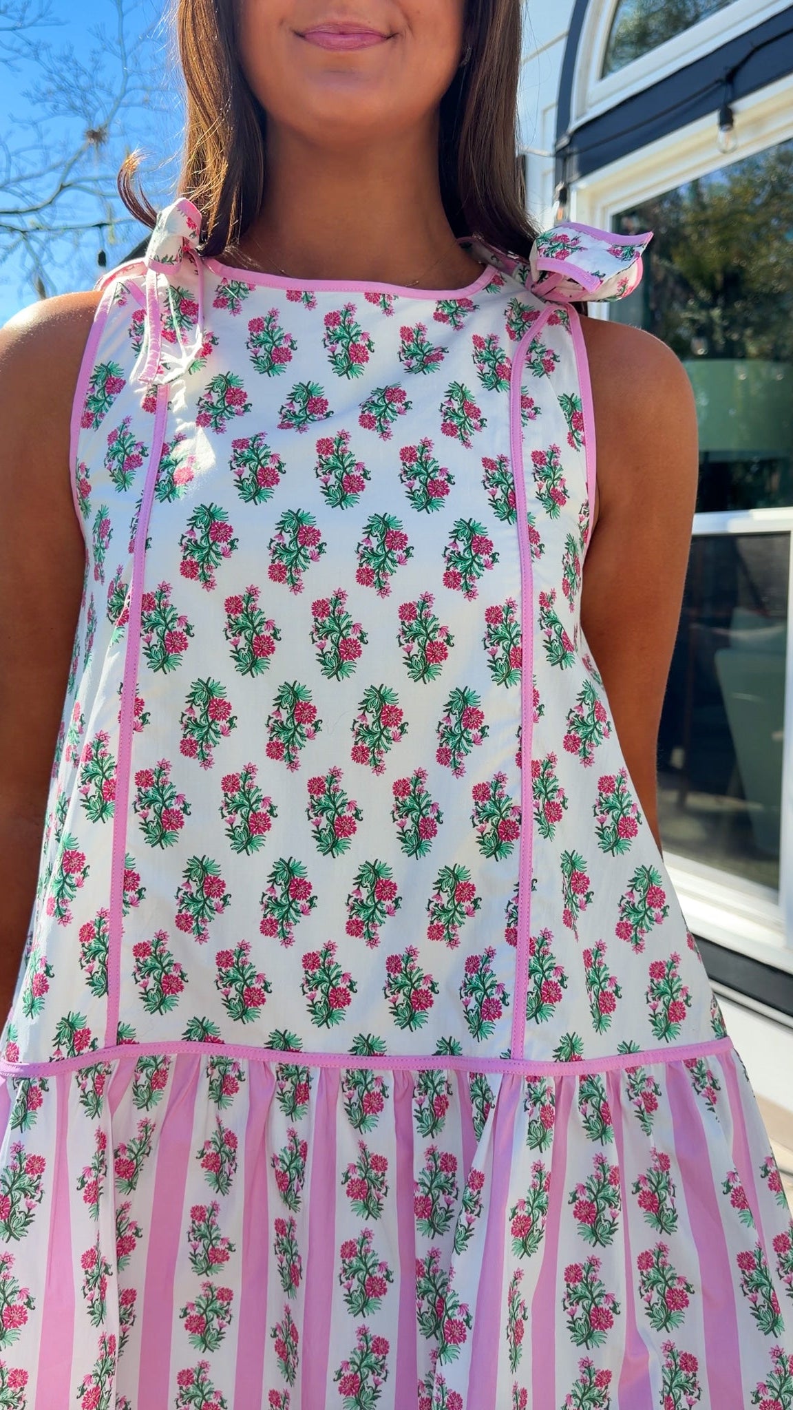 pink floral mini dress with ruffle hem and decorative shoulder bows