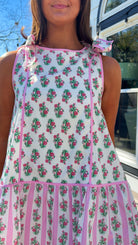 pink floral mini dress with ruffle hem and decorative shoulder bows