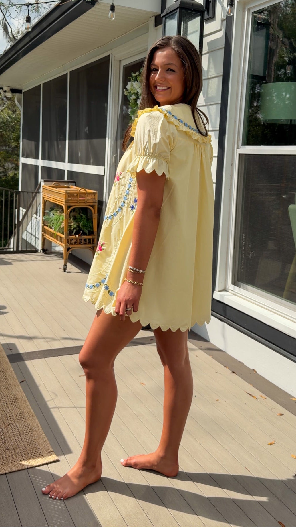 yellow mini dress with multicolor floral embroidery, ruffle collar, puff sleeves, and scalloped hem