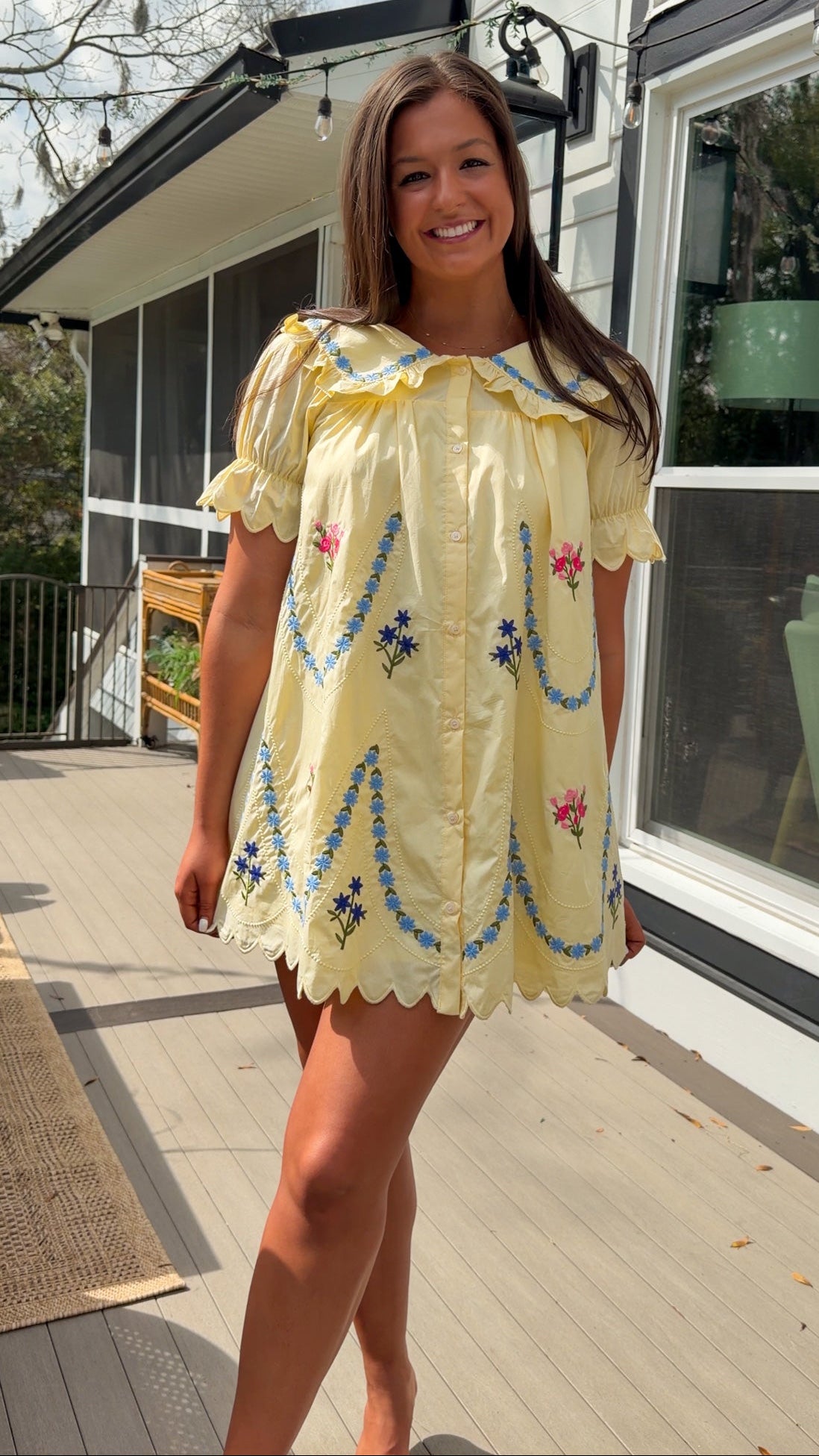 yellow mini dress with multicolor floral embroidery, ruffle collar, puff sleeves, and scalloped hem