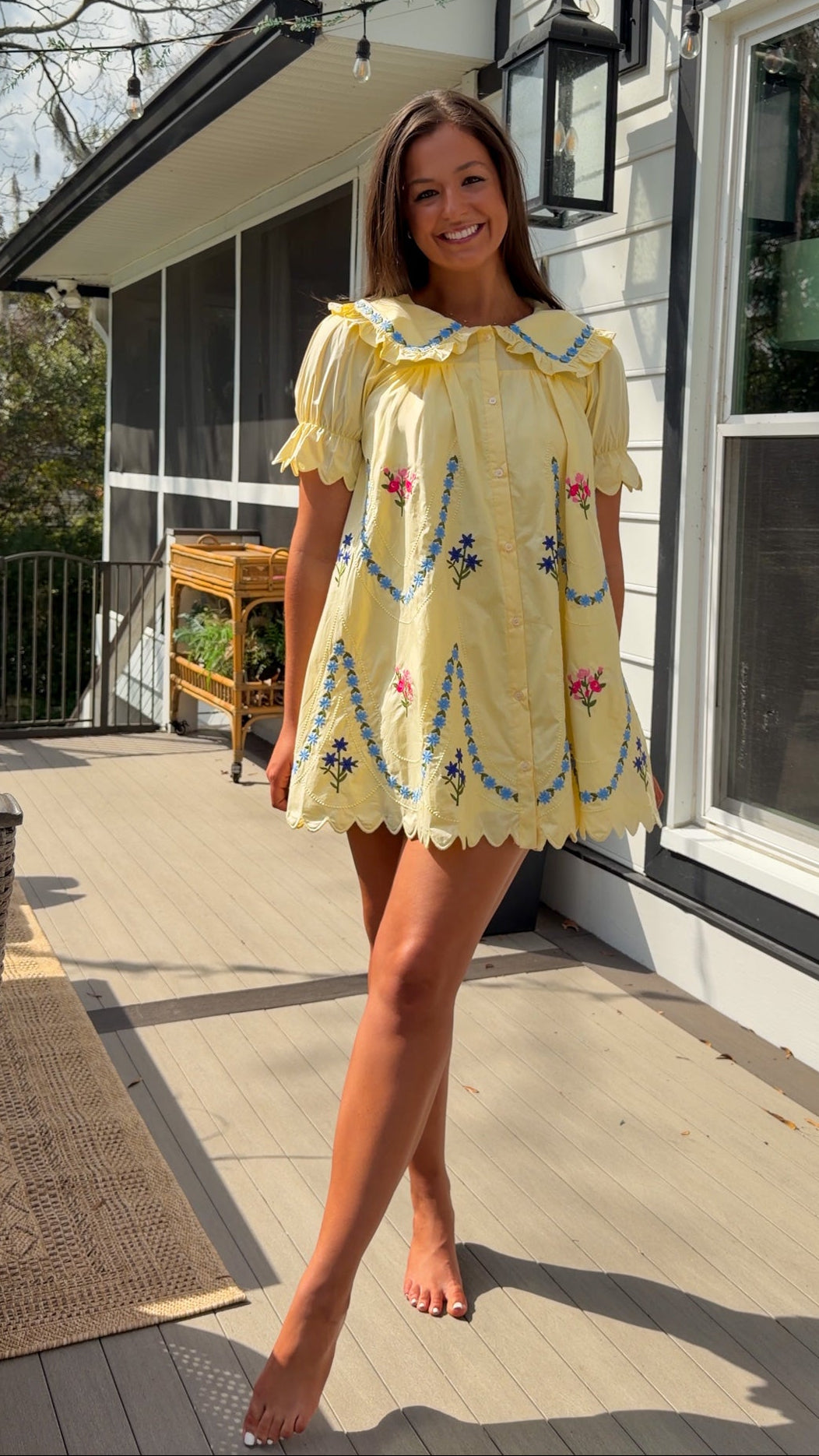yellow mini dress with multicolor floral embroidery, ruffle collar, puff sleeves, and scalloped hem