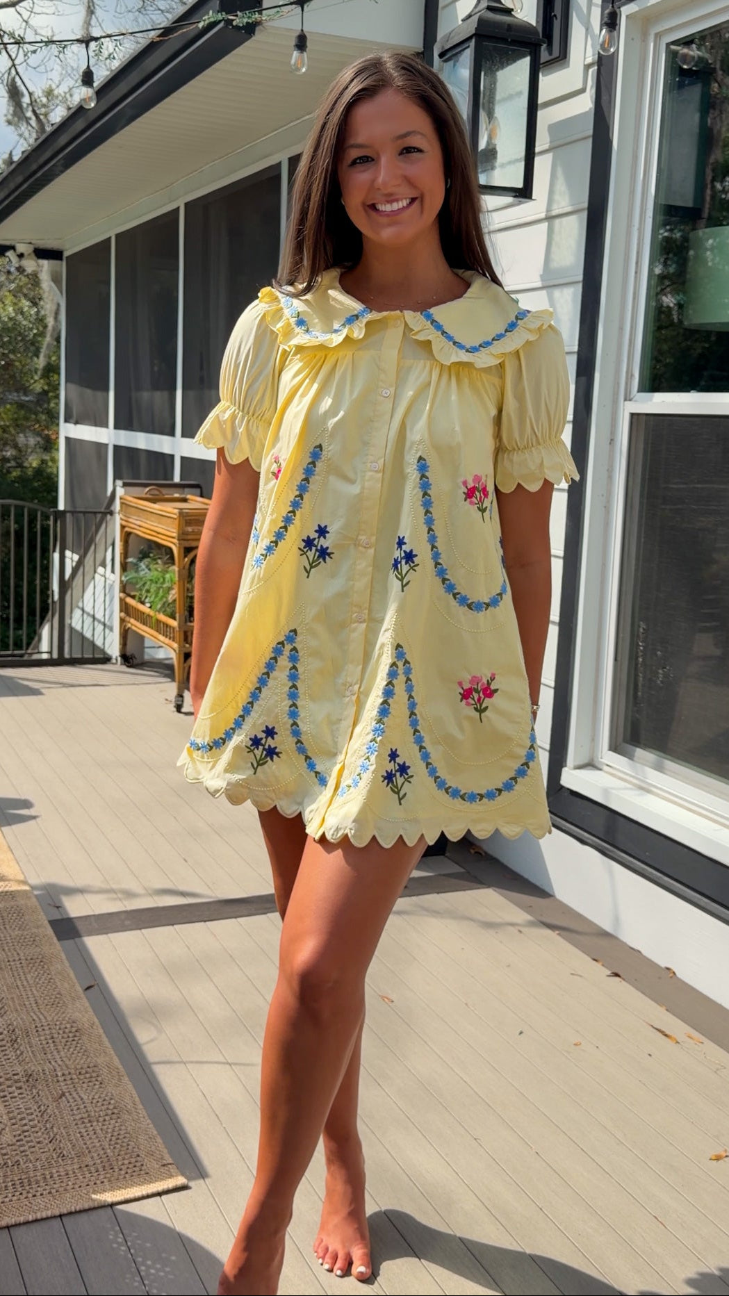 yellow mini dress with multicolor floral embroidery, ruffle collar, puff sleeves, and scalloped hem