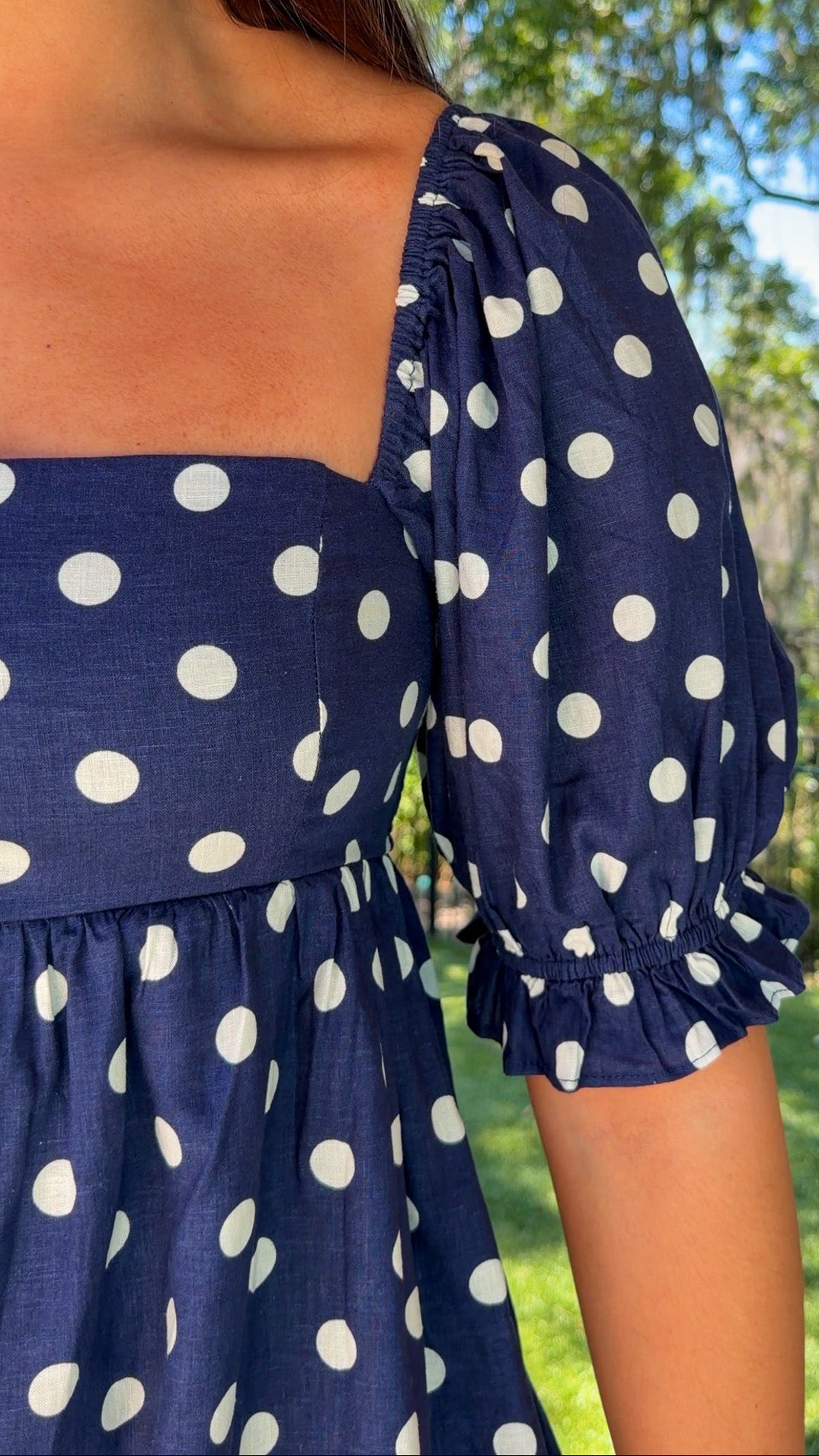 navy blue romper with white polka dots