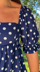 navy blue romper with white polka dots
