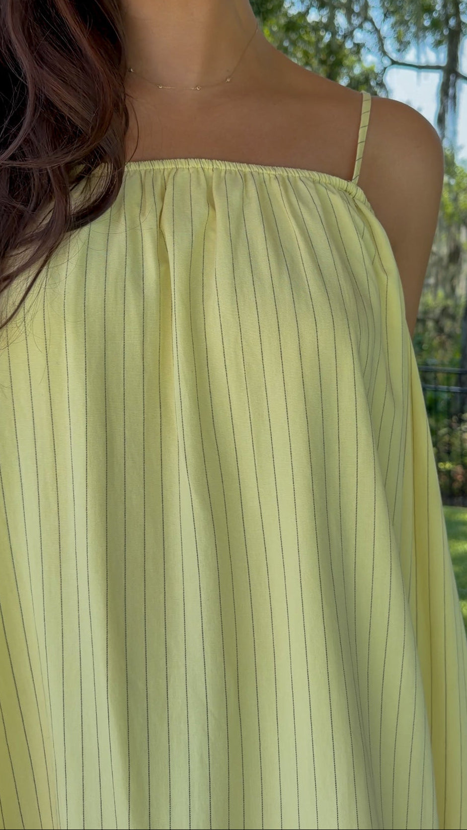 Butter yellow pinstripe maxi dress featuring adjustable spaghetti straps, a gathered square neckline, and a relaxed flowy silhouette in a lightweight woven fabric.