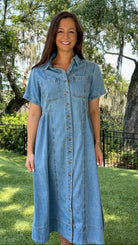 Light wash chambray midi dress featuring a collared neckline, functional button-front closure, oversized chest pockets, short sleeves, side pockets, and a relaxed silhouette.