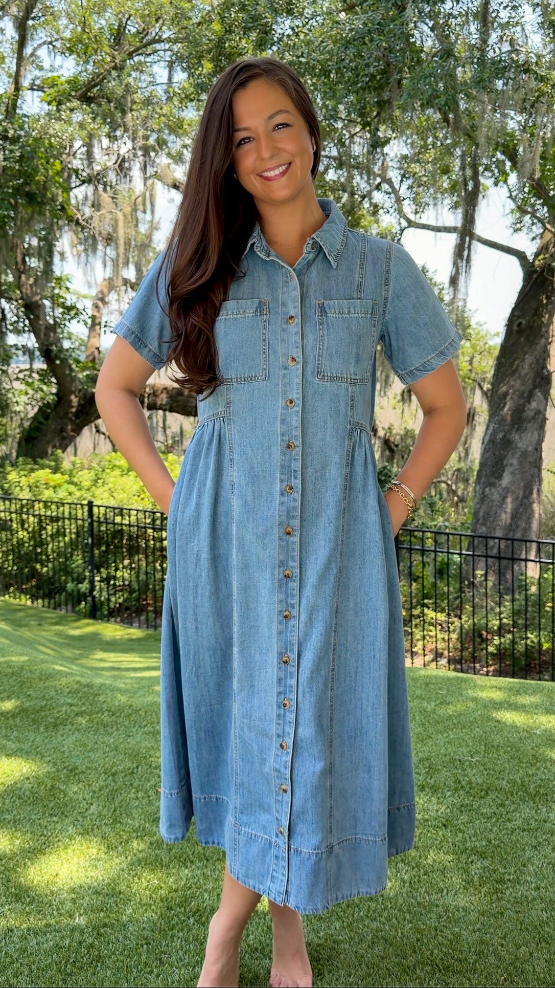 Light wash chambray midi dress featuring a collared neckline, functional button-front closure, oversized chest pockets, short sleeves, side pockets, and a relaxed silhouette.