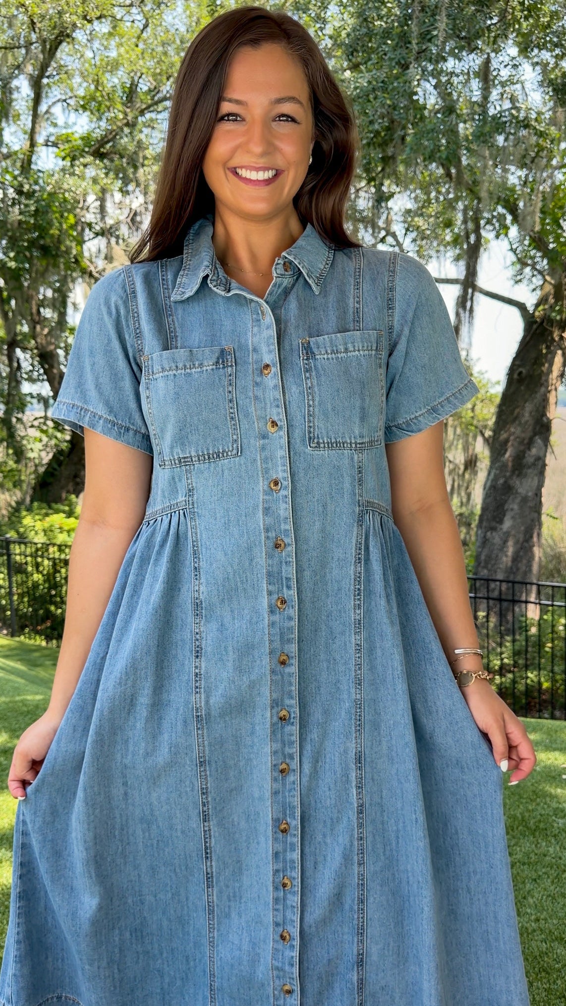 Light wash chambray midi dress featuring a collared neckline, functional button-front closure, oversized chest pockets, short sleeves, side pockets, and a relaxed silhouette.