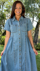 Light wash chambray midi dress featuring a collared neckline, functional button-front closure, oversized chest pockets, short sleeves, side pockets, and a relaxed silhouette.