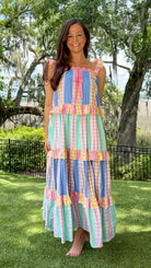 Pastel patchwork maxi dress featuring mixed check and stripe prints in pink, blue, yellow, and mint with ruffle straps, heart-shaped front pockets, lace trim, and a relaxed flowy silhouette.