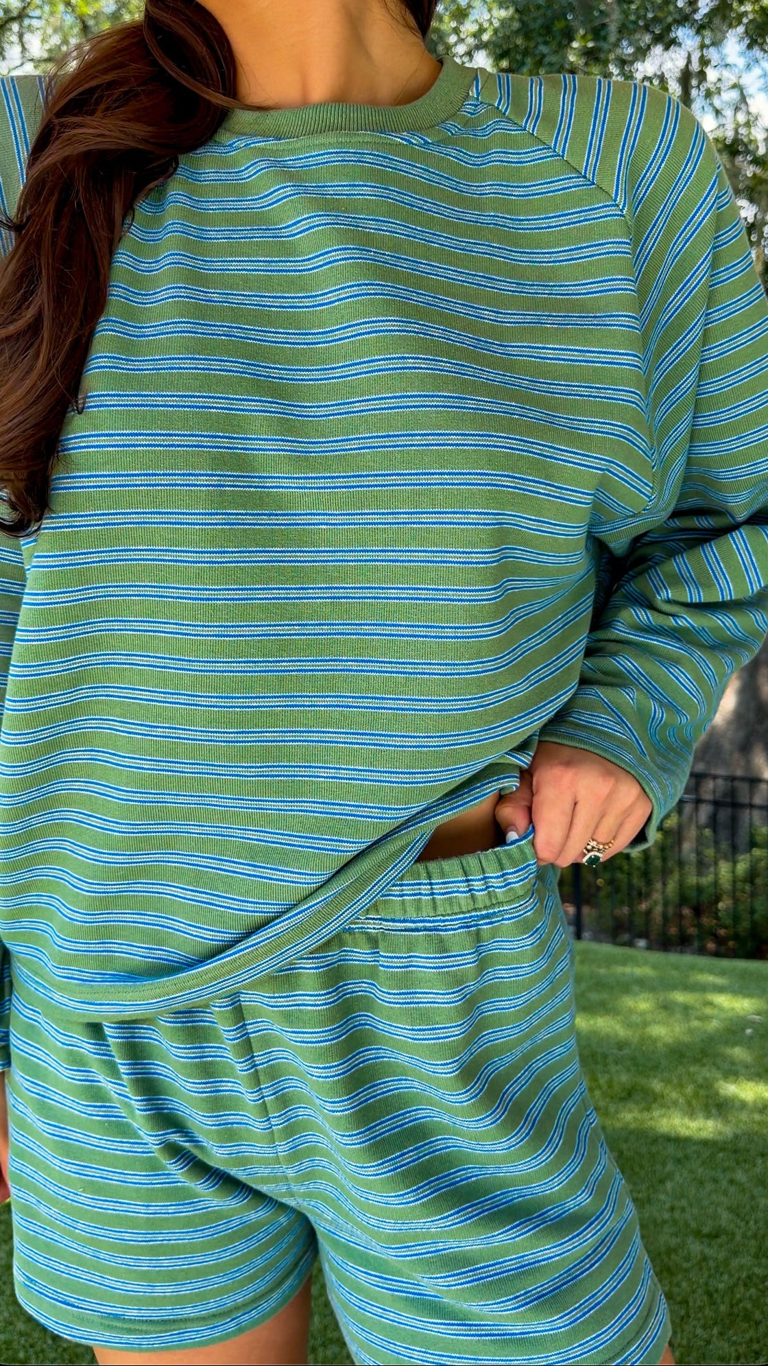 Olive and blue striped lounge set featuring a relaxed fit long sleeve crewneck top and matching elastic waist shorts with side pockets in a soft stretch knit fabric.