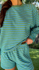 Olive and blue striped lounge set featuring a relaxed fit long sleeve crewneck top and matching elastic waist shorts with side pockets in a soft stretch knit fabric.