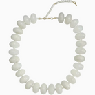 A white beaded necklace with smooth, rounded disc-shaped beads and a gold-tone clasp, shown on a plain white background.