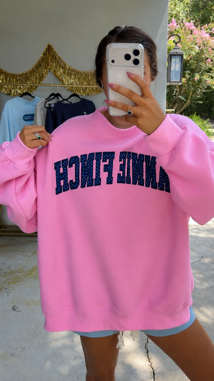 pink mockneck sweatshirt with navy and white polka dot "annie finch" embroidery 