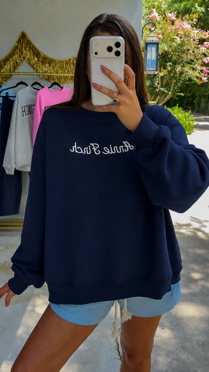 navy crewneck with white "annie finch" script embroidered on front