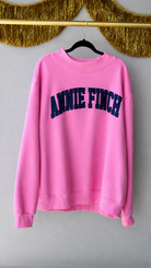 pink mockneck sweatshirt navy and white dot "annie finch" embroidery